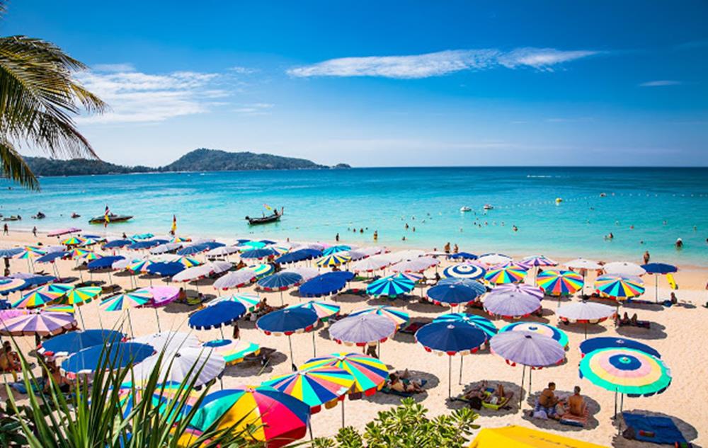 PHUKET, THAILAND- JAN 23, 2016: Crowds of tourists at Patong beach on Jan 23, 2016 in Phuket, Thailand. Phuket is a popular destination famous for its beaches.