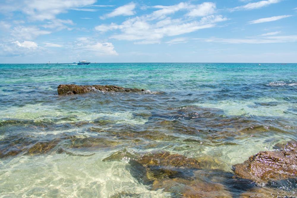 Sandy beach with rocks and crystal clear water in Thailand