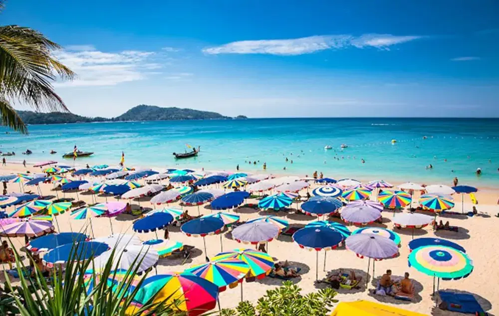 PHUKET, THAILAND- JAN 23, 2016: Crowds of tourists at Patong beach on Jan 23, 2016 in Phuket, Thailand. Phuket is a popular destination famous for its beaches.